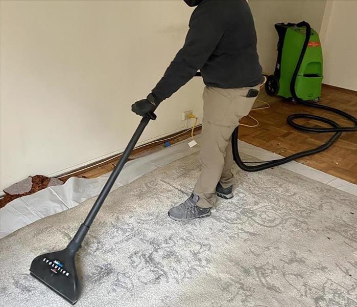 SERVPRO Employee Extracting Water From A Carpet