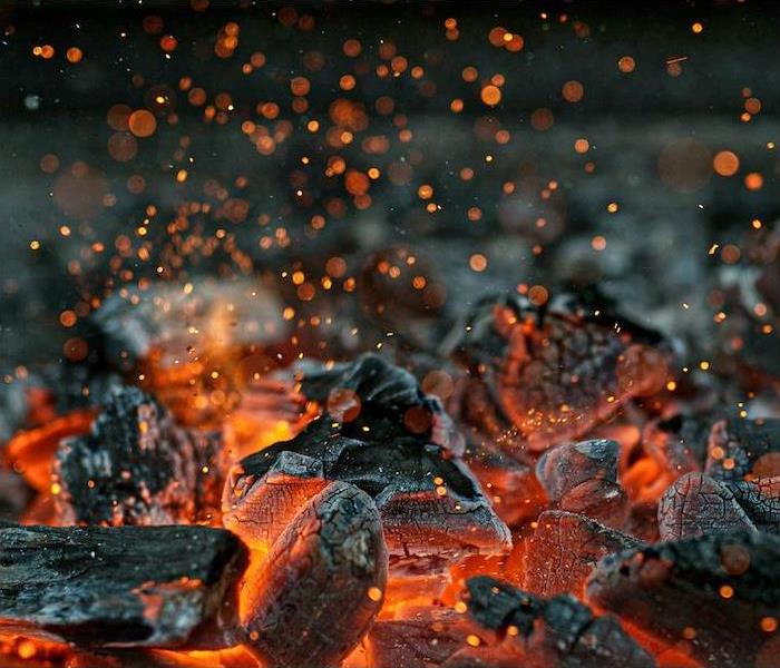 Close up shot of searing hot coals burning brightly on their undersides